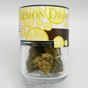 An eighth of the THCA flower strain Lemon Drop in a glass jar.