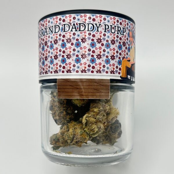 An eighth of the THCA strain Granddaddy Purp aka GDP or Grandaddy Purp in a glass jar.