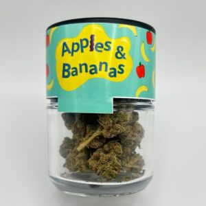 An eighth of the THCA flower Apples & Bananas in a glass jar.