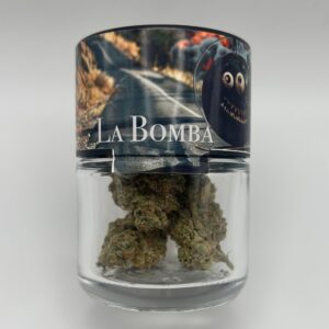 An eighth of the THCA flower strain La Bomba in a glass jar.