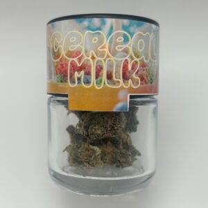 An eighth of Cereal Milk, a THCA flower strain in a glass jar from Dama Botanicals.