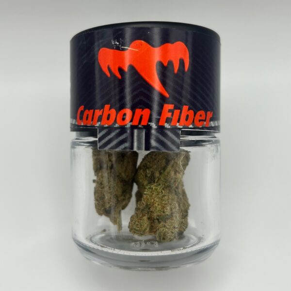 An eighth of the THCA flower Carbon Fiber in a glass jar; sold by Dama Botanicals.