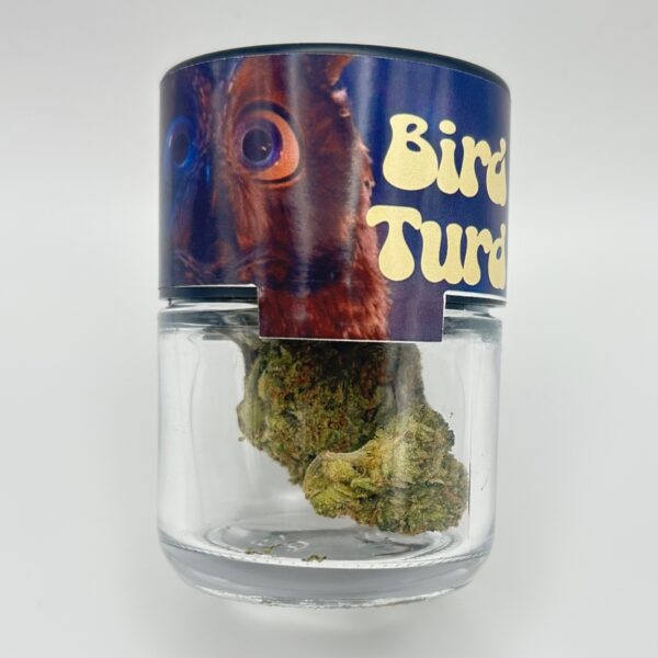 An eighth of the THCA strain Bird Turd in a glass jar from Dama Botanicals.