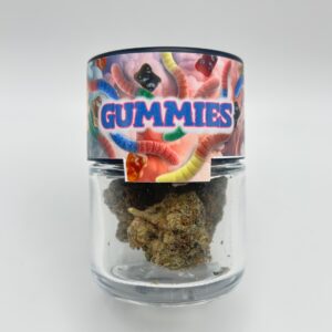 An eighth of the THCA flower strain Gummiez in a glass jar from Dama Botanicals.